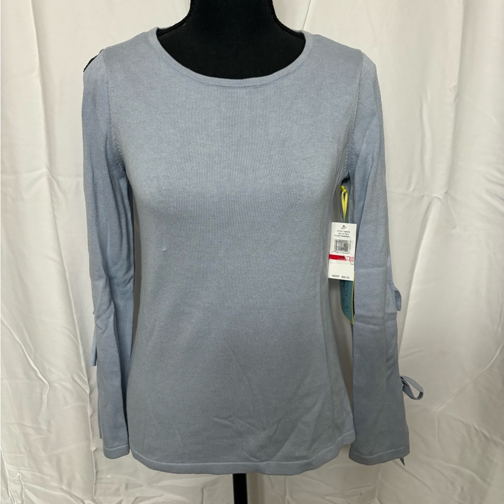 NWT A beautiful light blue sweater with cutouts on the arms.